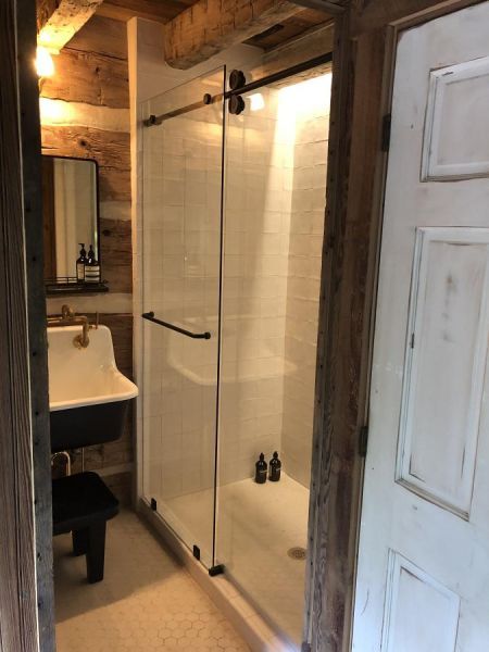 Barn-style door glass shower doors by Weatherford Glass